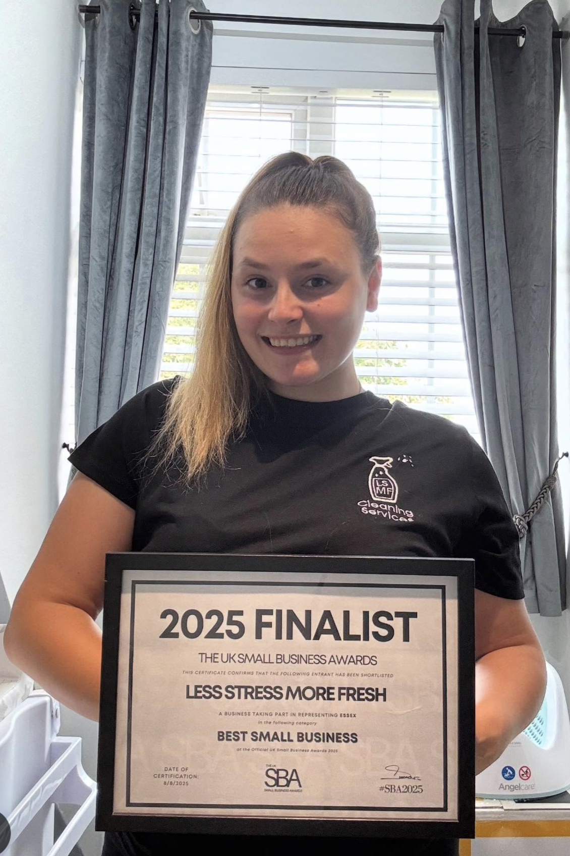 Leanne, owner of Less Stress More Fresh, holding the UK Small Business Awards 2025 Finalist certificate
